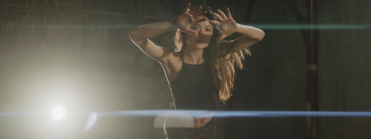 A woman dancing in a large studio