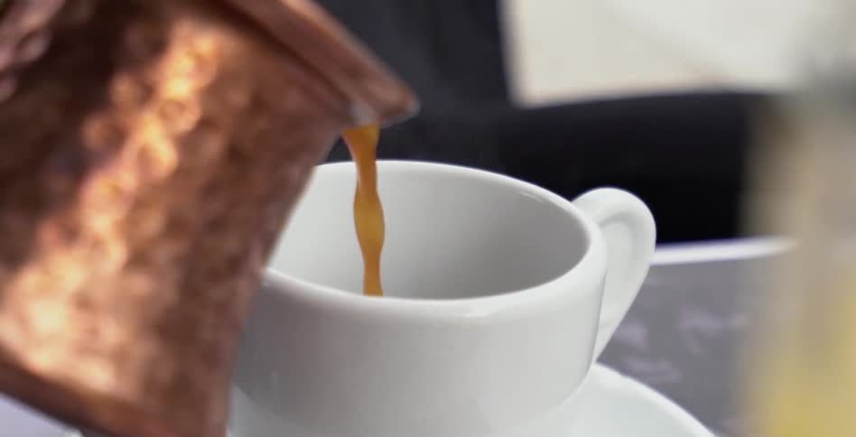 A hot liquid is poured into a mug