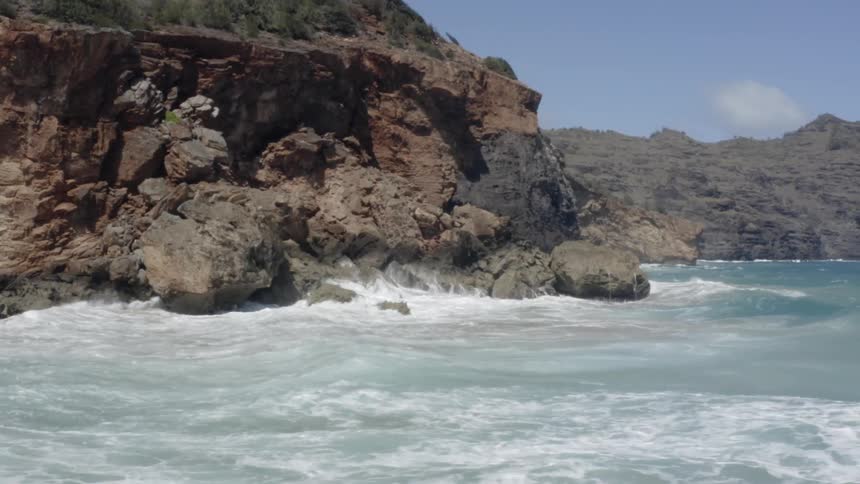Waves crashing on rocky cliff
