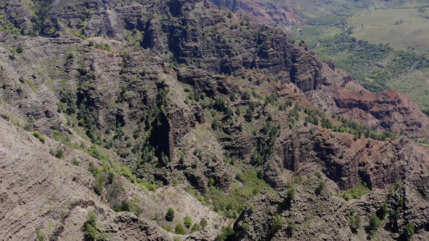 The camera flies over a rocky mountainous area