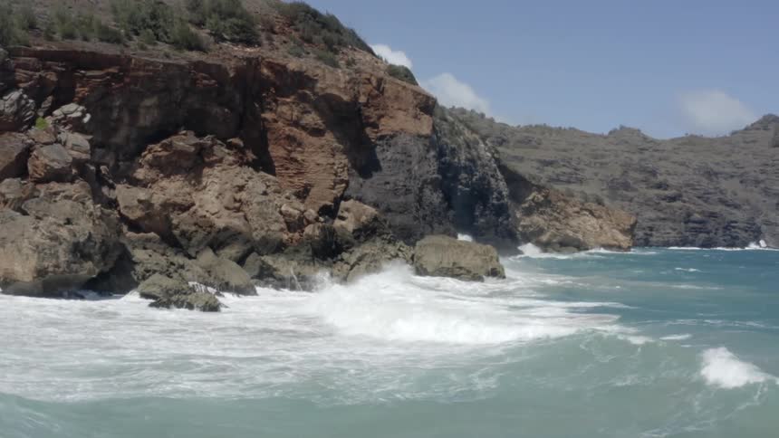 Ocean waves crash on rocky shore