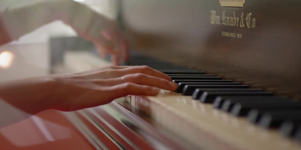 Close up of person's hands playing piano
