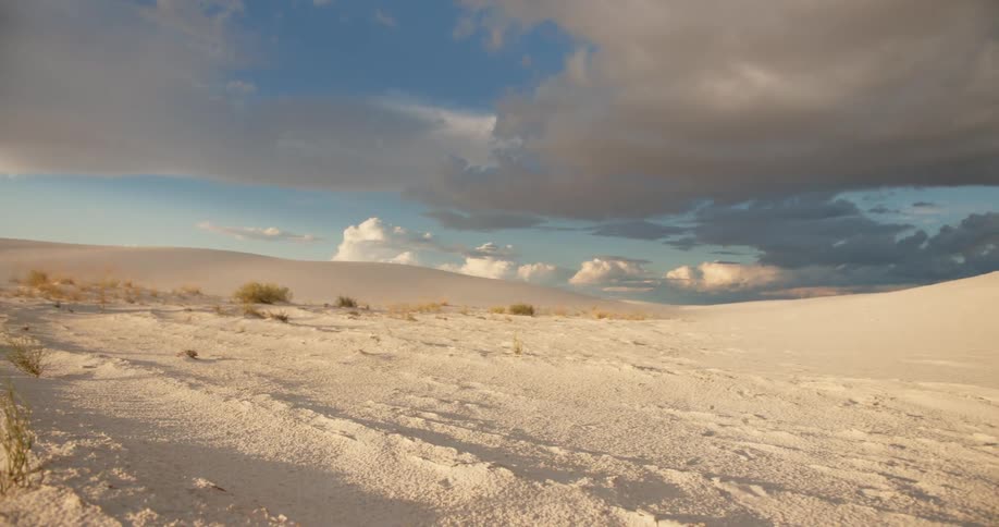 Desert sands and dunes under dark clouds