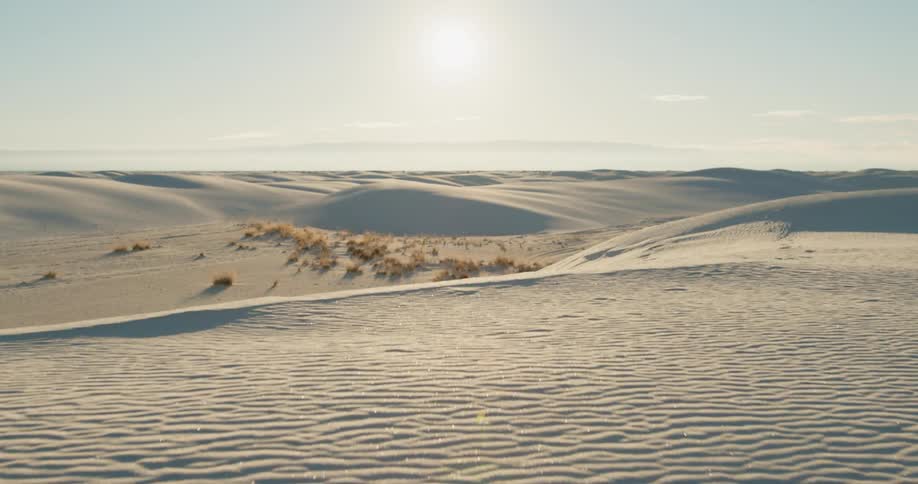 Rippled sand covers a desert landscape on a sunny day