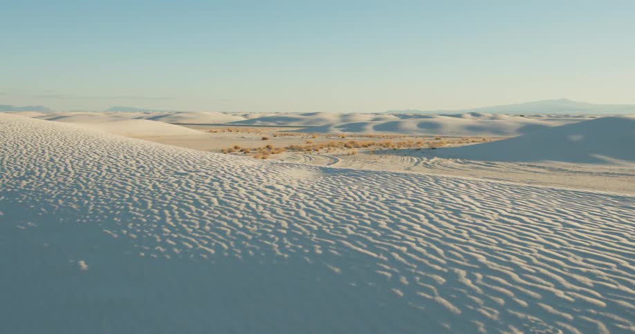 Rippled sand and dunes cover a desert landscape