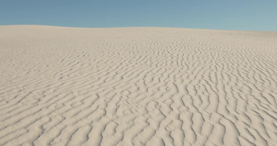 Moving up a sandy dune toward the top