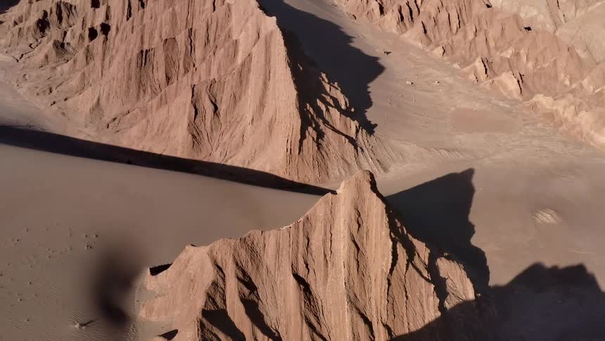 Several jagged hills stand out from a barren desert landscape