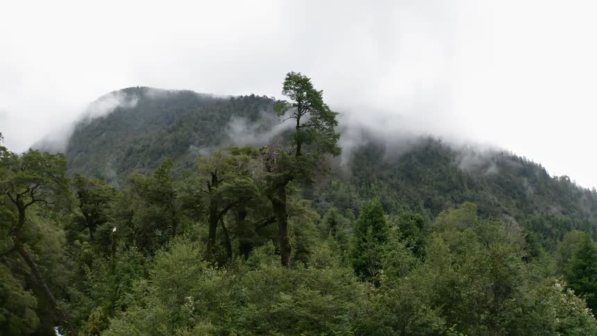 Clouds falling on high hill tops