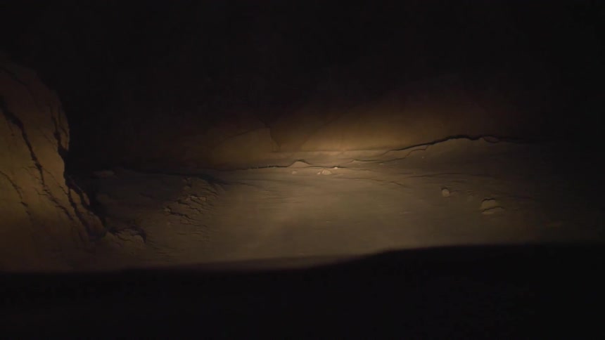 A car is driving in a desert area