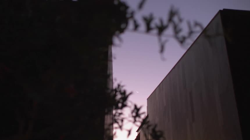 Looking up at the sky between two buildings