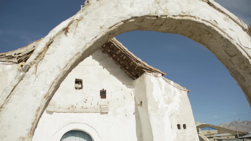 Cement church sits under a blue sky