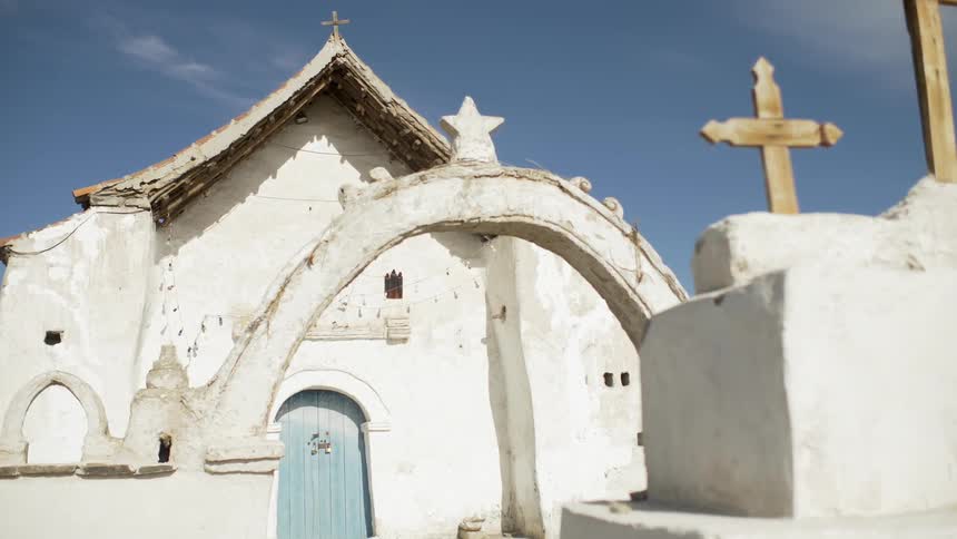 White adobe church with gold crosses