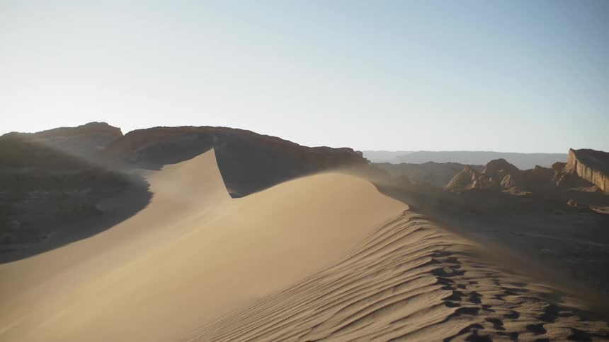 Sand dunes stretch into the distance