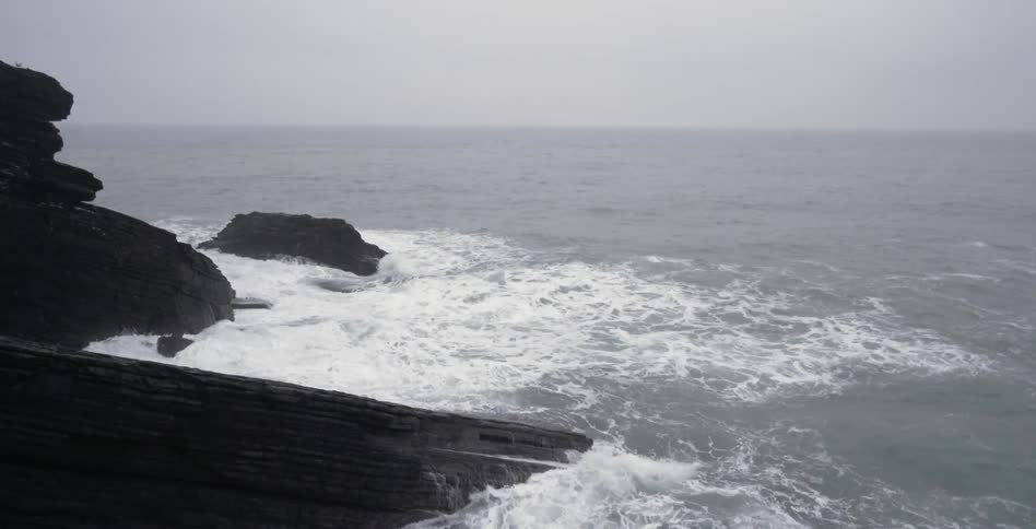 Waves crash against the rocks