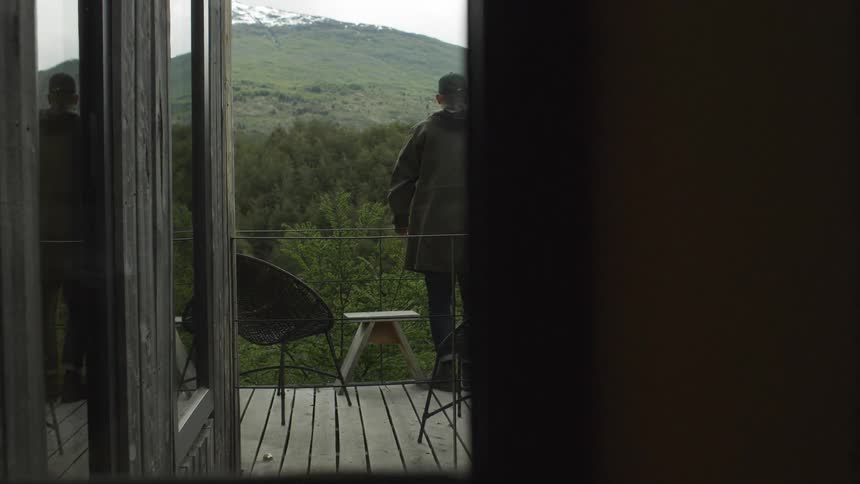 Man standing on a balcony at the railing