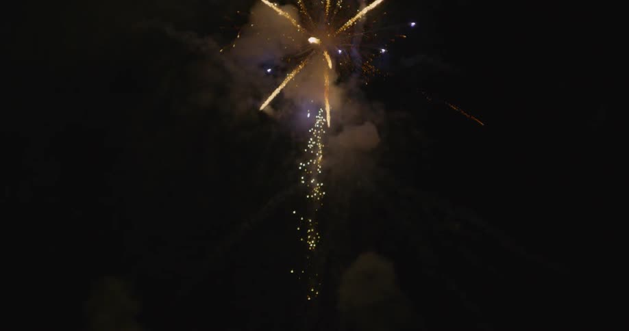 A firework explodes in the night sky