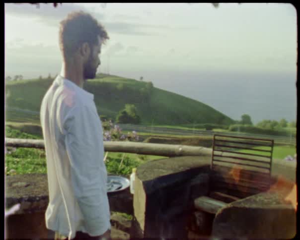 Man looks at stone barbecue