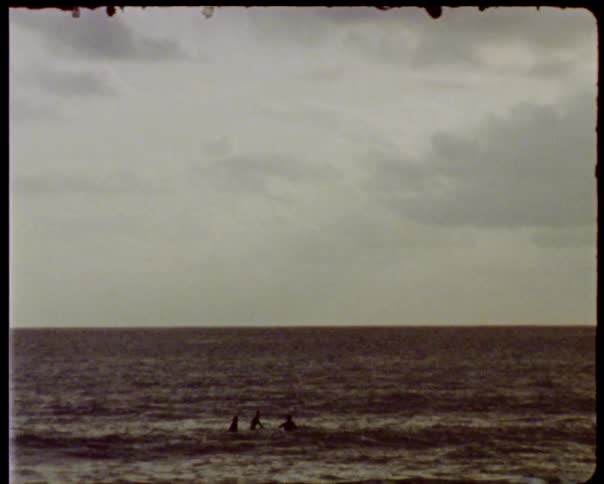 Three people playing in the ocean