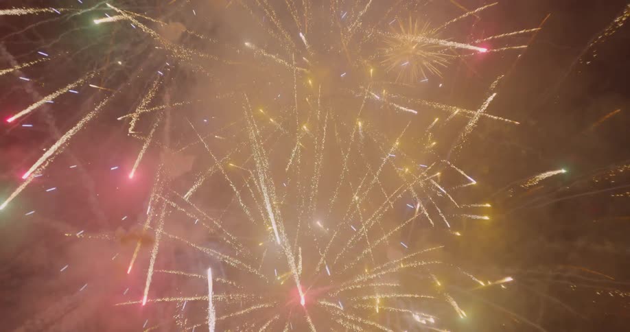 Fireworks shooting up and exploding in the sky