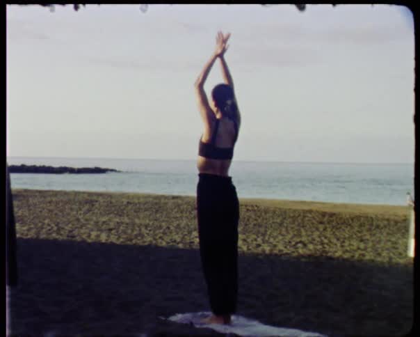 People do yoga on a beach