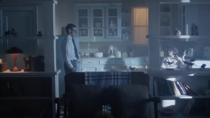 A man walks into a room and talks to his wife