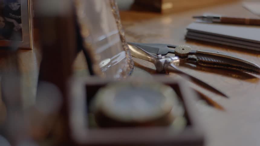 Compass sits in box on table near other navigational tools
