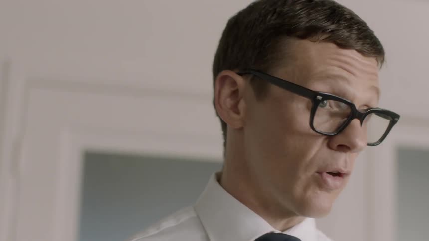 Man in glasses talking to someone