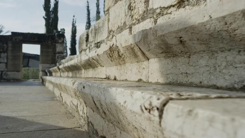 A stone wall sits in a town setting