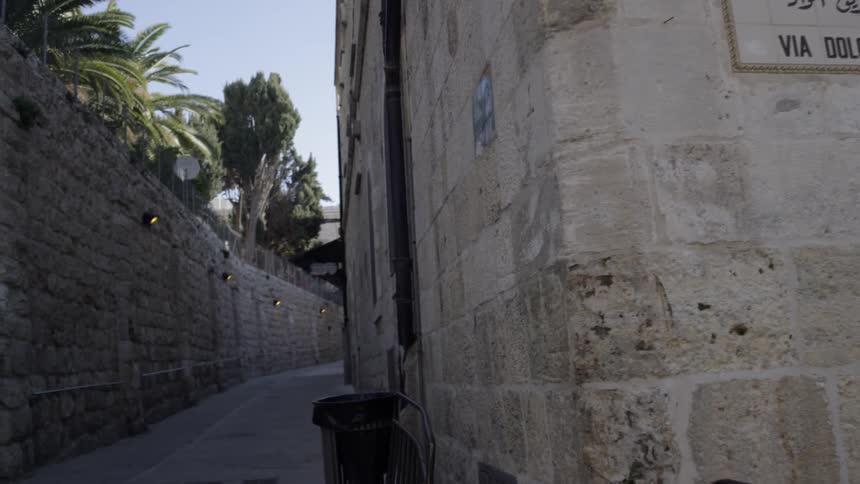 An alleyway behind a building in the old city of jerusalem during the day