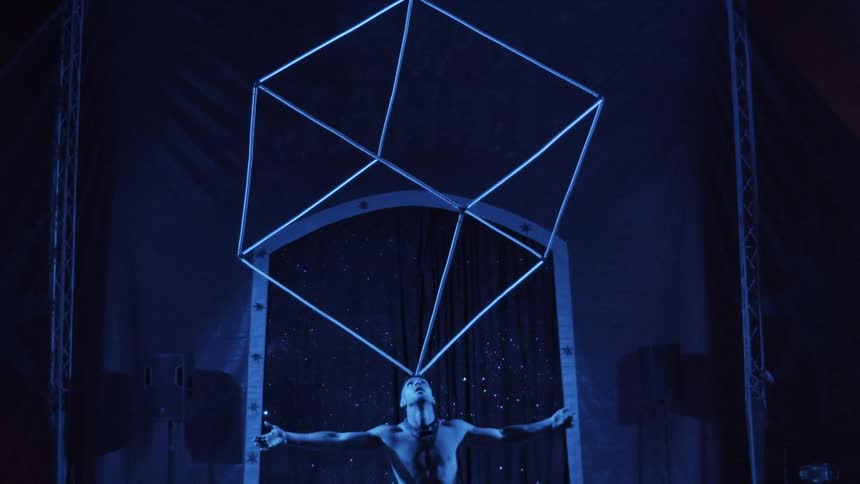 Man holding a cube on forehead