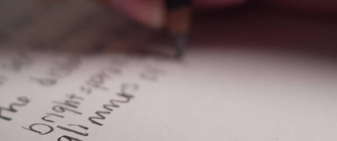 A person writing on paper