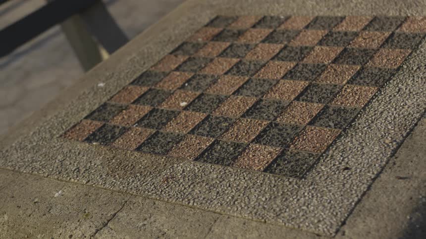 A chess board on a concrete block in a public park