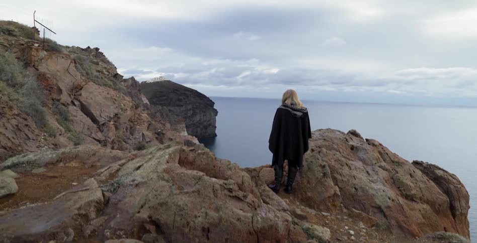 A woman standing on rocks
