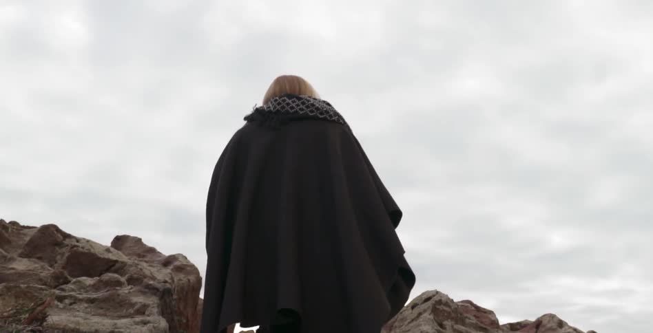 Woman ascends a rocky path