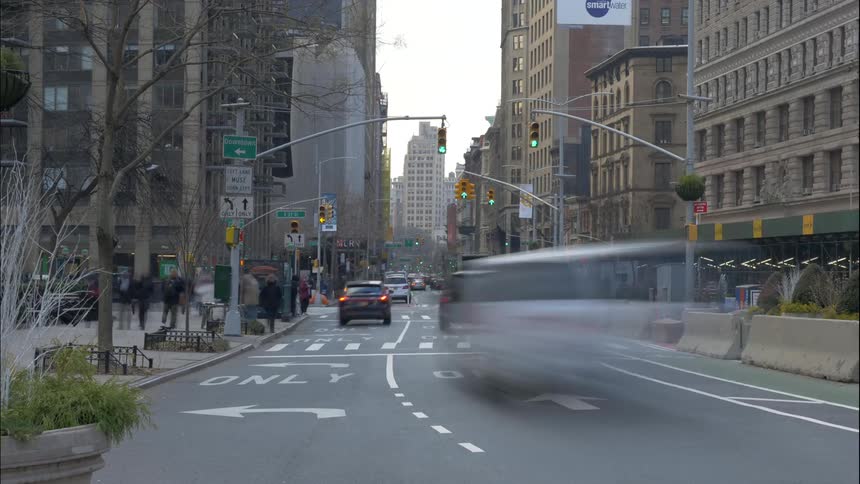 A downtown area with people buildings and traffic