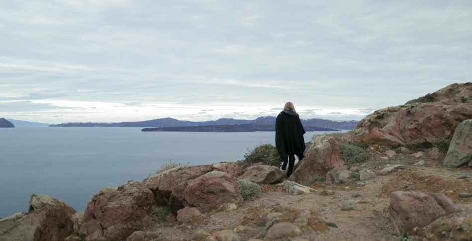 A woman walking on rocks