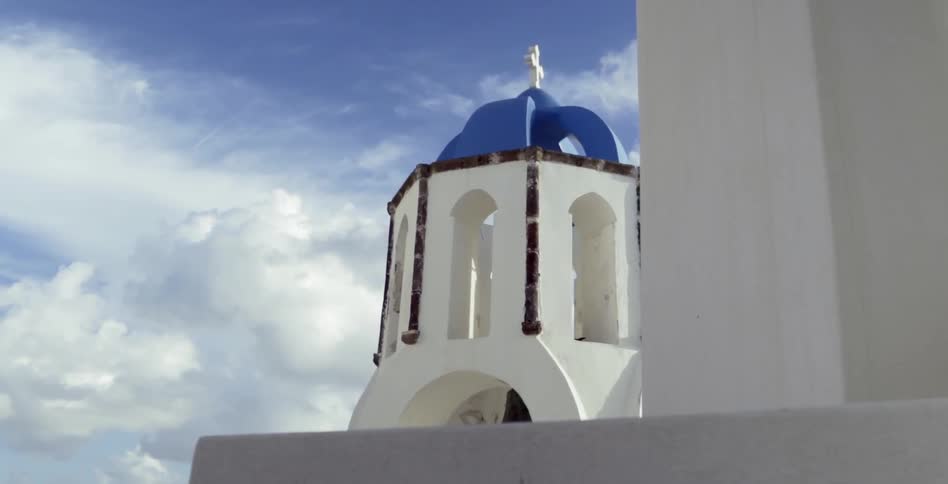 A church steeple sits against a cloudy backdrop