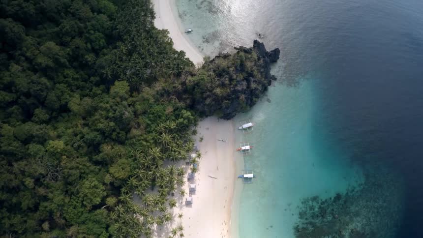 Water flows calmly along a beach shoreline