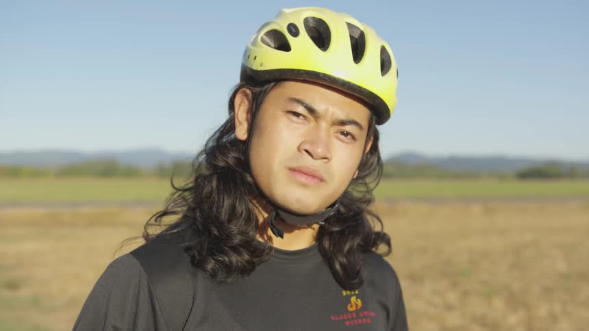 A man wearing a bicycle helmet