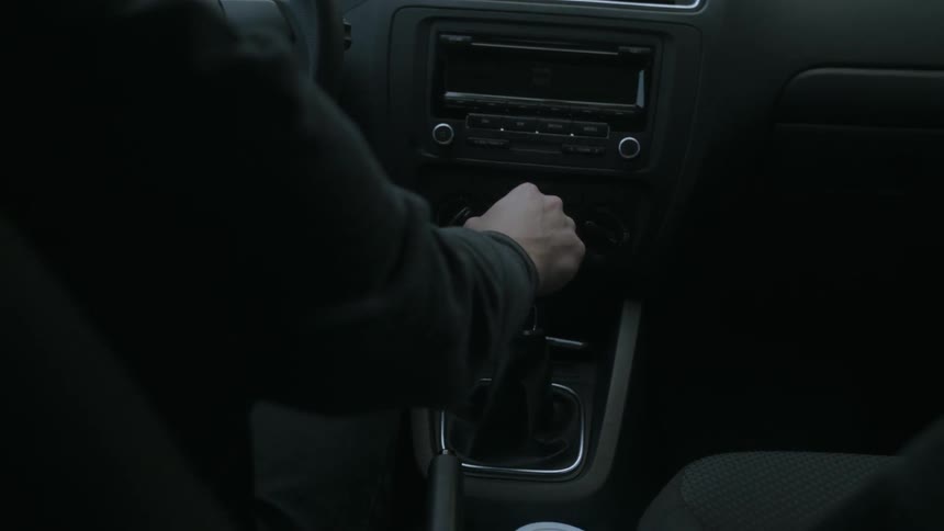 A person shifting gears