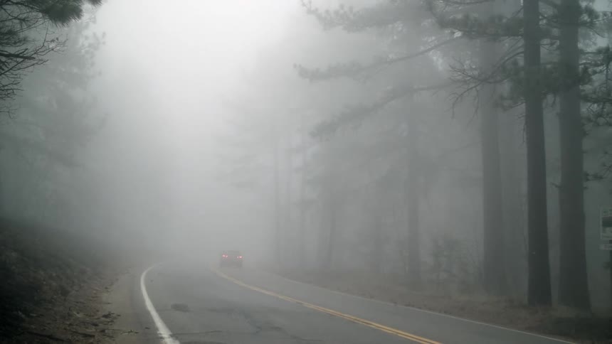 A car driving into the fog