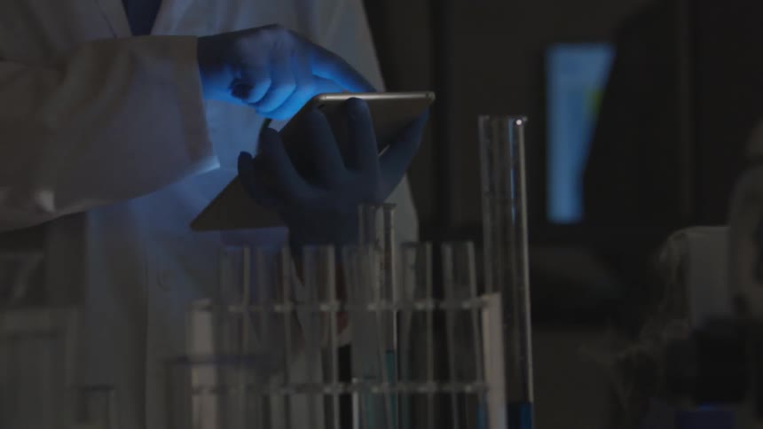A man uses a tablet in a laboratory