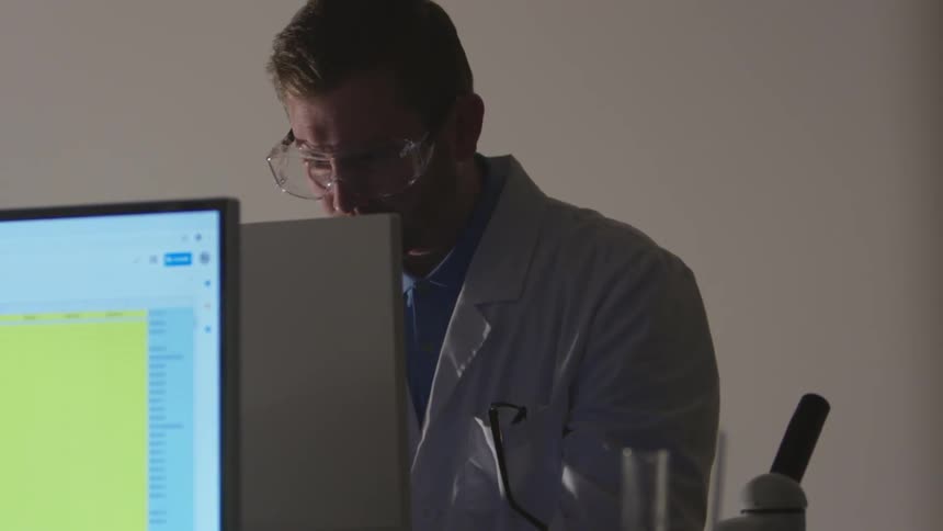Scientist examine microscope in lab