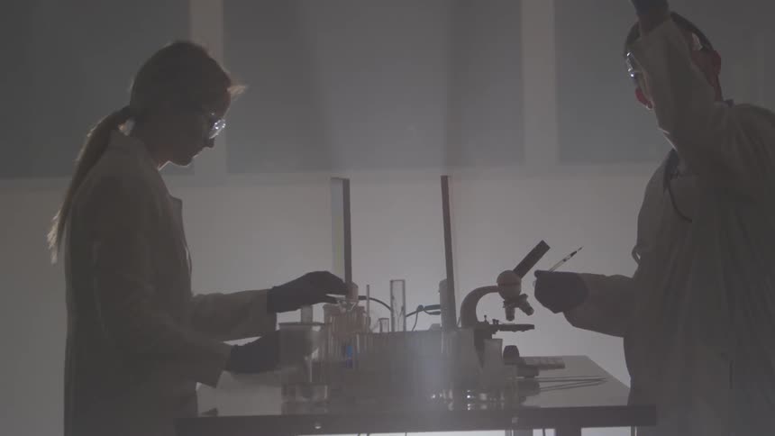 Scientists working with test tubes