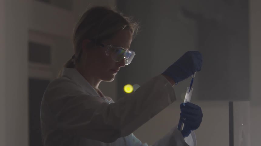 A woman and another person working inside a lab