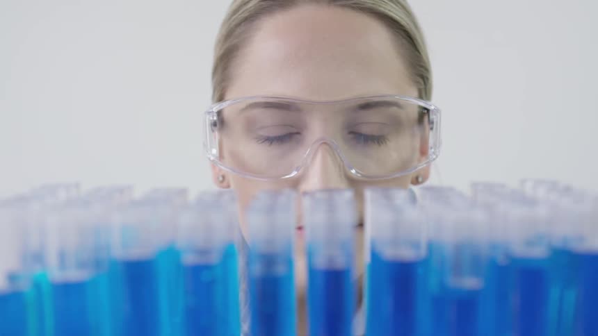 A girl looking at test tubes