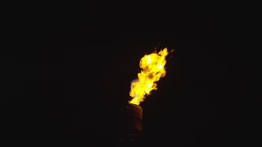 Flames burning from a torch at night time