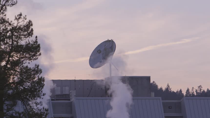 Smoke rises past roof satellite dish