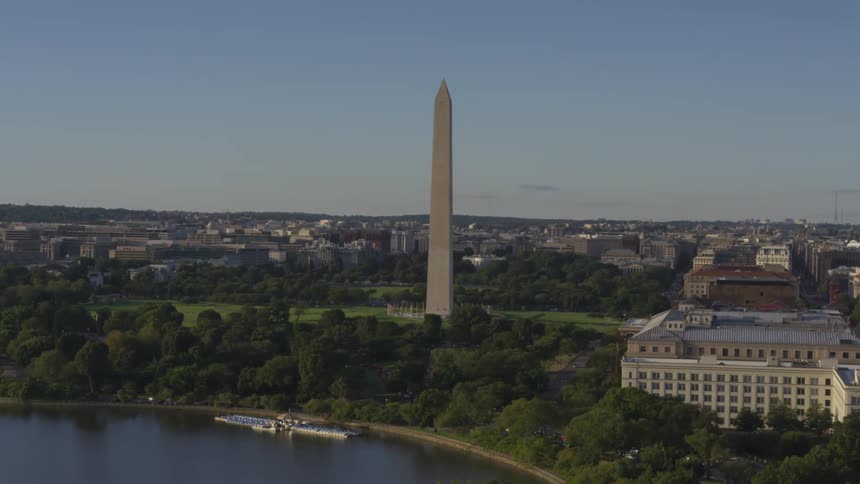 Washington memorial style obelisk among low office building near water