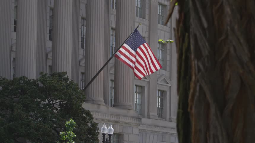 American flag hanging proudly on a courthouse building